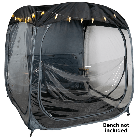 A WeatherPod pop-up tent pod in dark gray with a black detachable roof, featuring clear PVC, string lights along the top, and the WeatherPod logo printed on the back. on a white background with a text overlay that says 'Bench not included'.