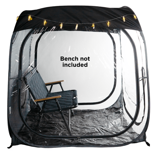A WeatherPod pop-up tent pod in dark gray with a black detachable roof, featuring clear PVC, string lights along the top, and the WeatherPod logo printed on the back. on a white background with a text overlay that says 'Bench not included'.